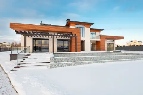 Modern home with wide entry steps in fresh snow