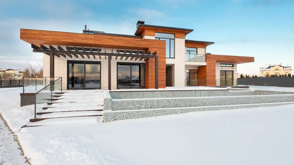 Modern home with wide entry steps in fresh snow